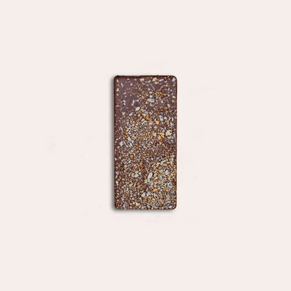 'Crow & Moss Chocolate bar unwrapped against a light pink bacground