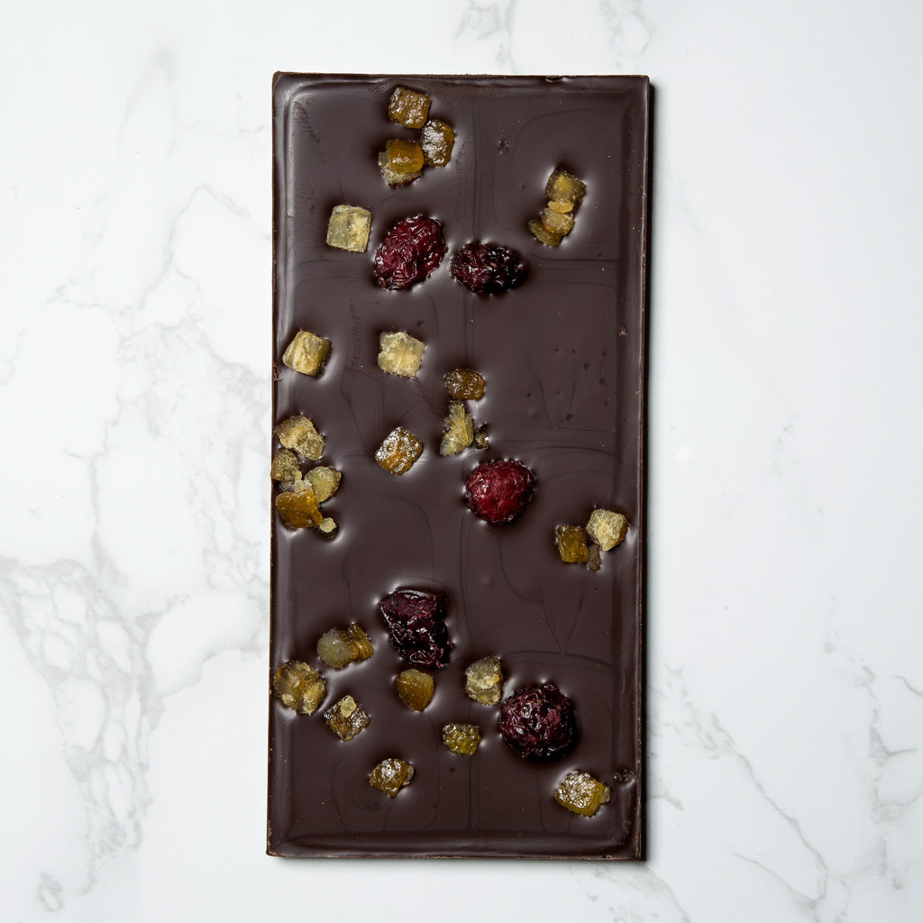 An open Ritual Orange Cranberry Bar with dried fruits on a marble surface