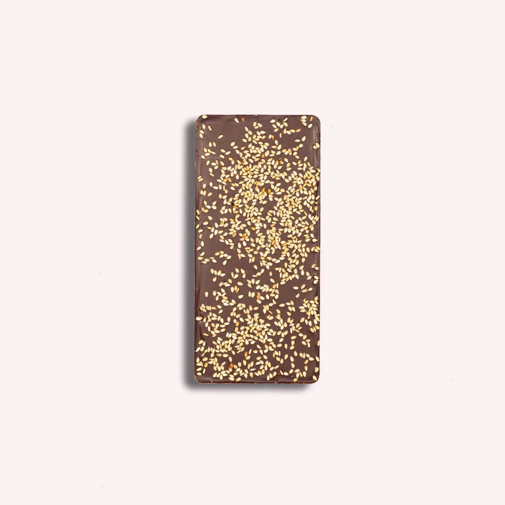 Chocolate bar with gold sprinkles on a white background