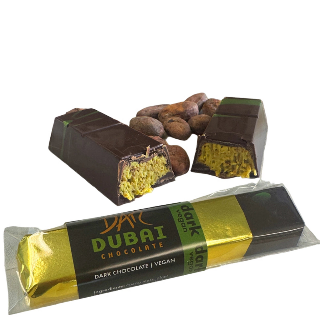 DAR Dubai Dark Chocolate bar, unwarpped and in packaging, with cacao beans against a white background