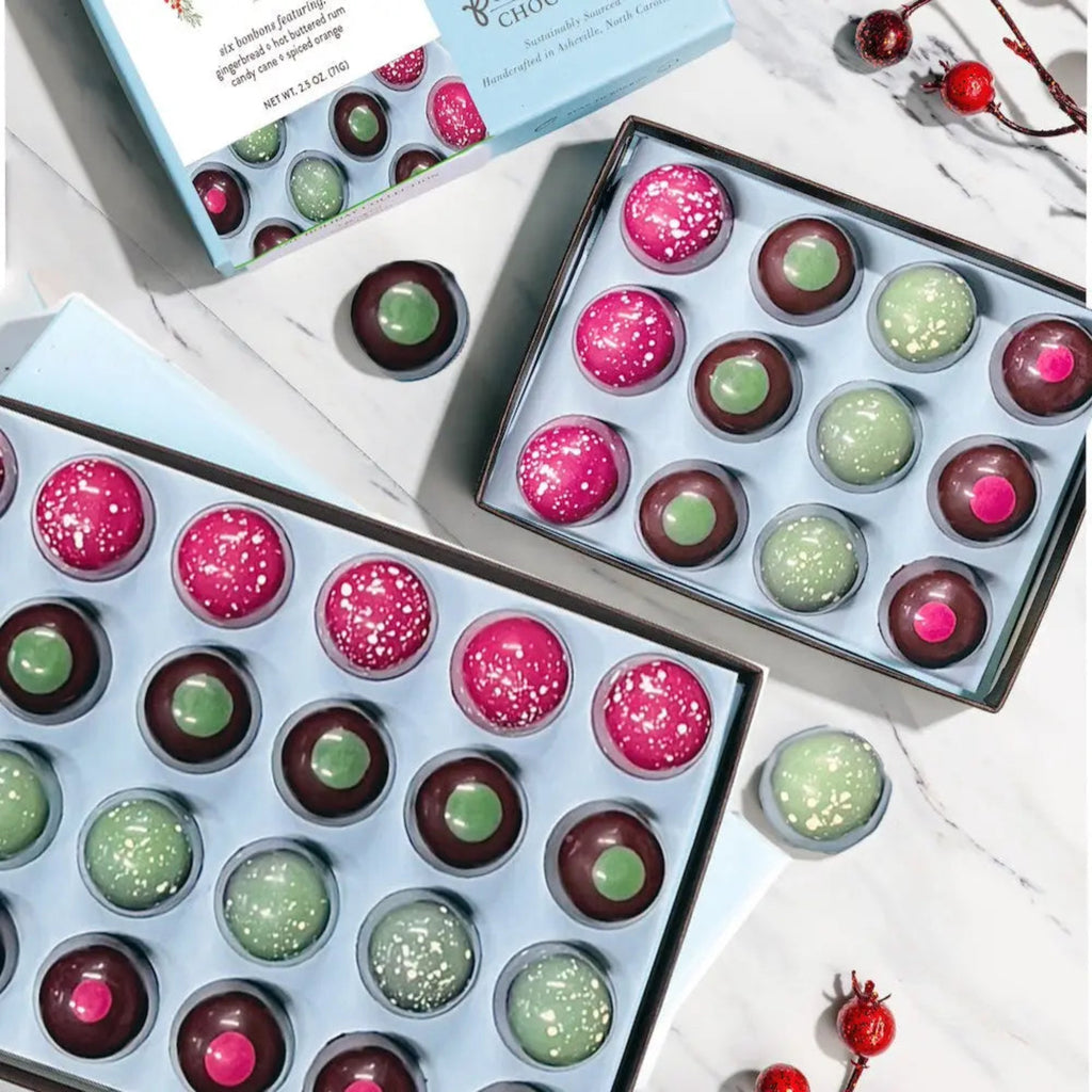 2 Boxes of French Broad Chocolates Holiday Collection of Bonbons - 12pc against a marble surface surface