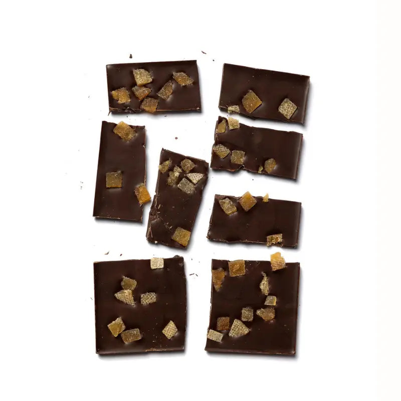 Unwrapped, broken pieces of 70% Cupuaçu against a white background