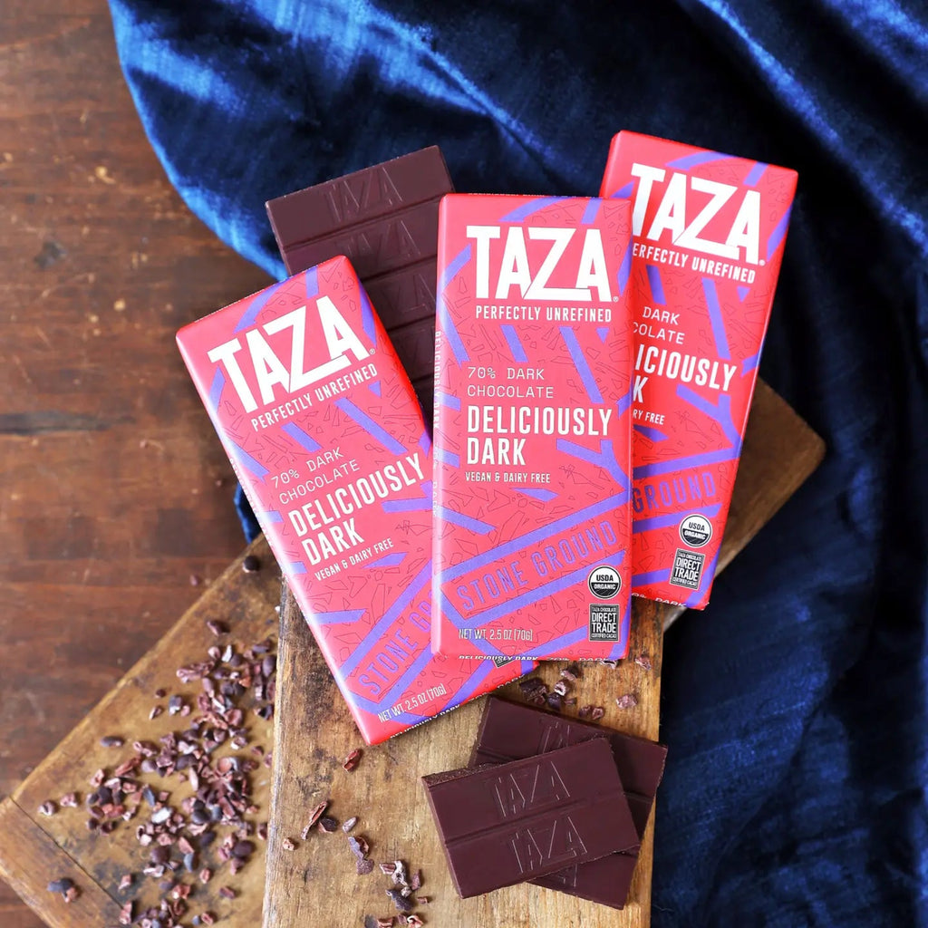 Taza chocolate bars on a wooden board with a blue cloth in the background