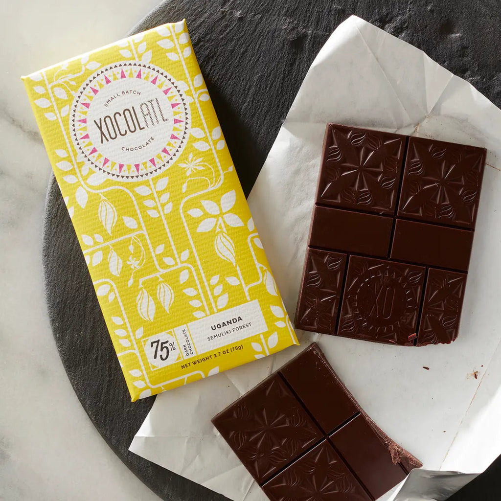 Xocolatl Uganda 75% Dark Chocolate bar, unopened and open,  on a gray marble surface
