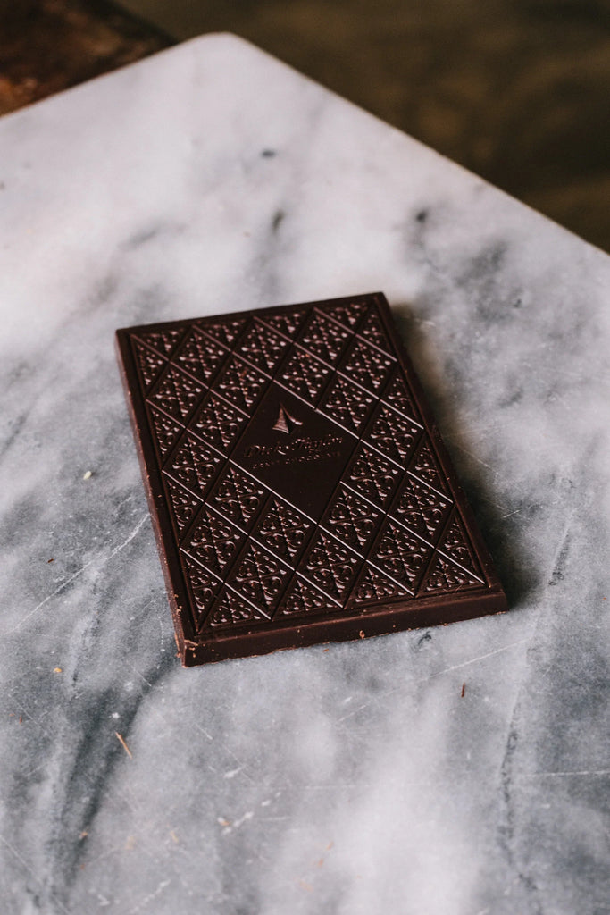 An unwrapped Fleur de Sel bar on a marble table from Dick Taylor