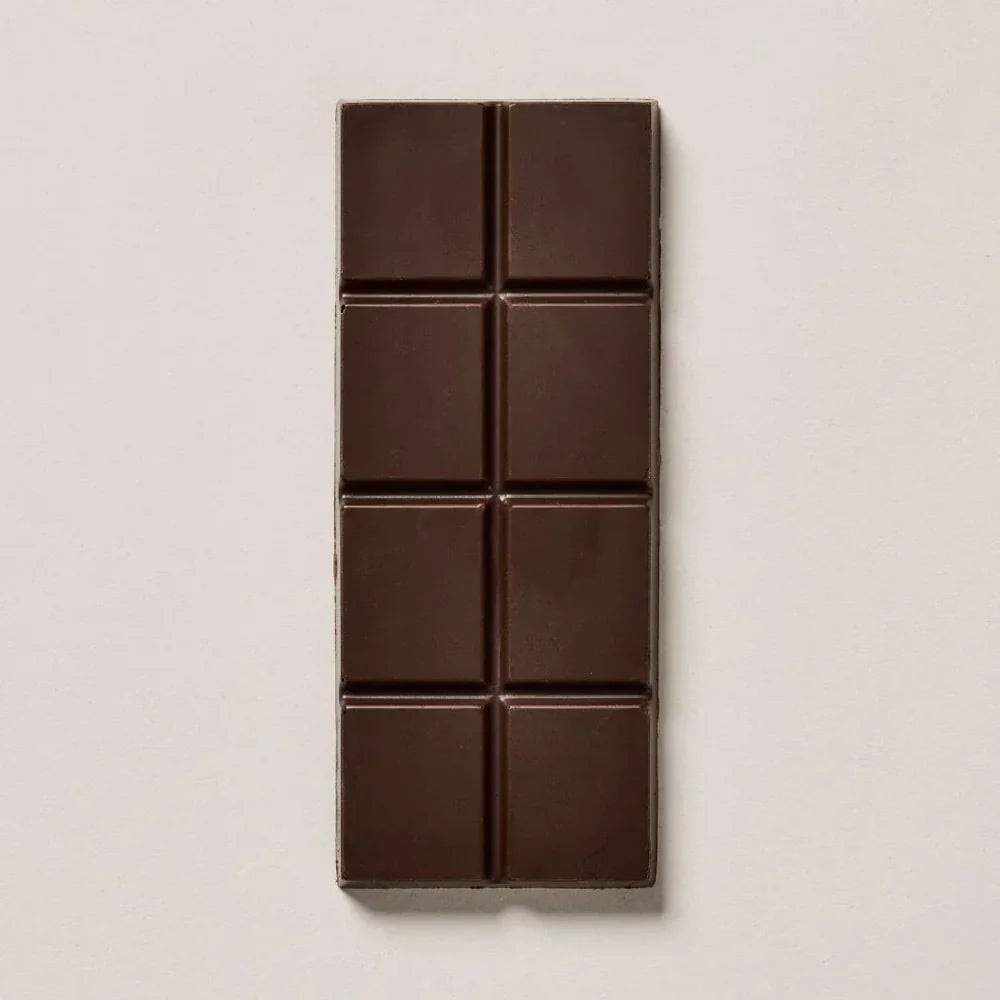 Unwrapped Endorfin Citradelic Dark 70% bar from Coracao on an off-white table