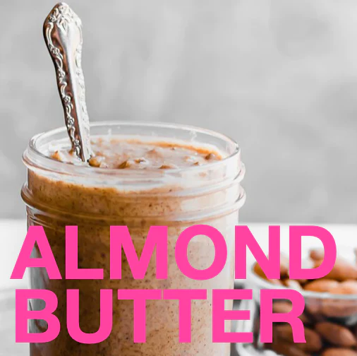 A jar of almond butter with a spoon in it.