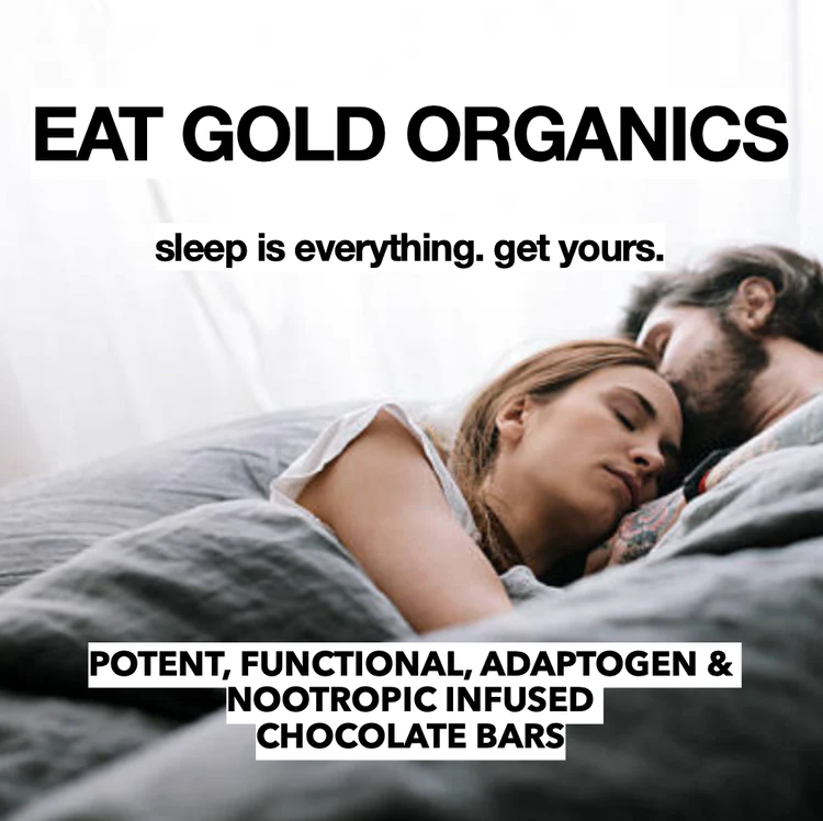 A couple sleeping on a grey bed.