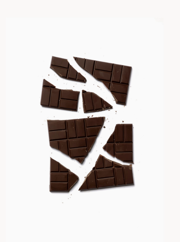 A broken 85% Cacao - Brazil bar against a white background
