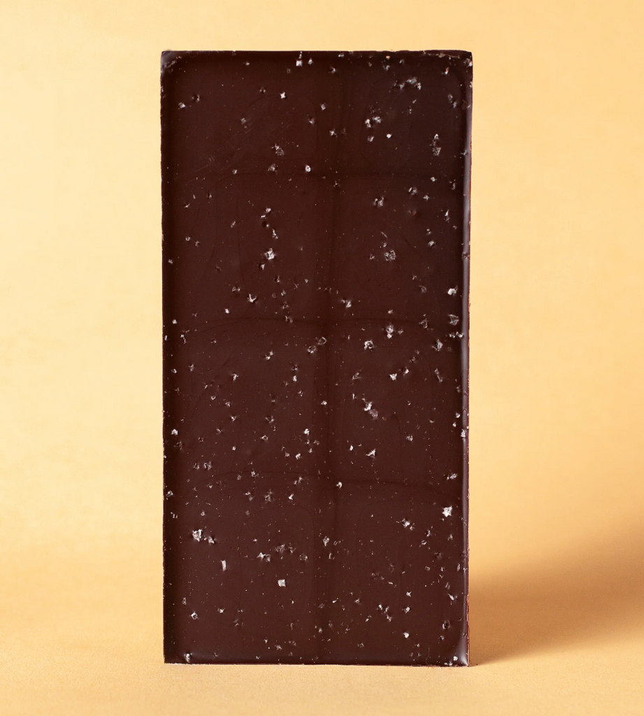 Unwrapped 72% Sea Salt Dark Chocolate against a yellow background