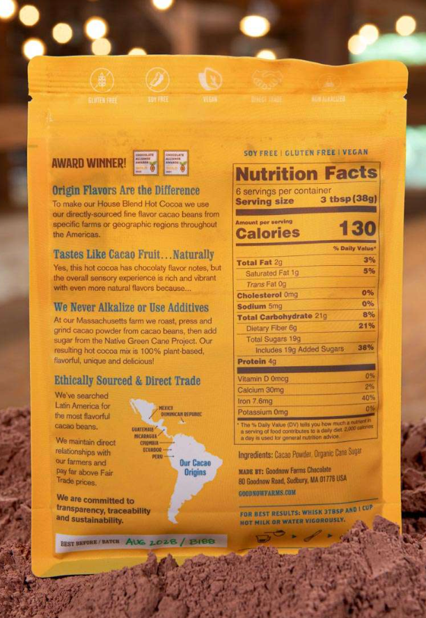 Nutrition facts and ingredients for House Cocoa Blend on a bed of cocoa powder