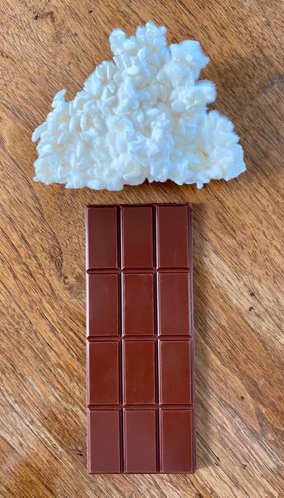 Unwrapped 55% Caramelized Koji Mylk on a wooden table with koji rice