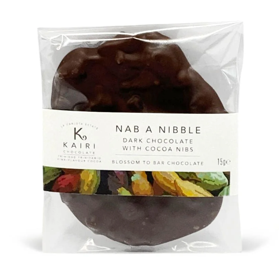 The front of a wrapped Dark Chocolate w/ Cocoa Nibs bar from Kairi against a white background