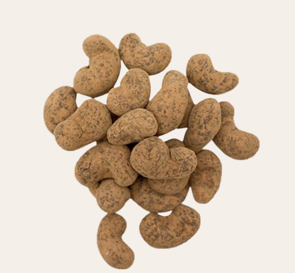 Multiple unwrapped Chocolate Covered Cashews from Rawmio against an off-white background
