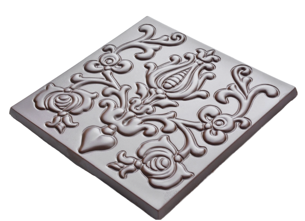  Rozsavolgyi Chocolate with/ Candied Cacao Nibs in Palinka 73% unwrapped against a white wood background