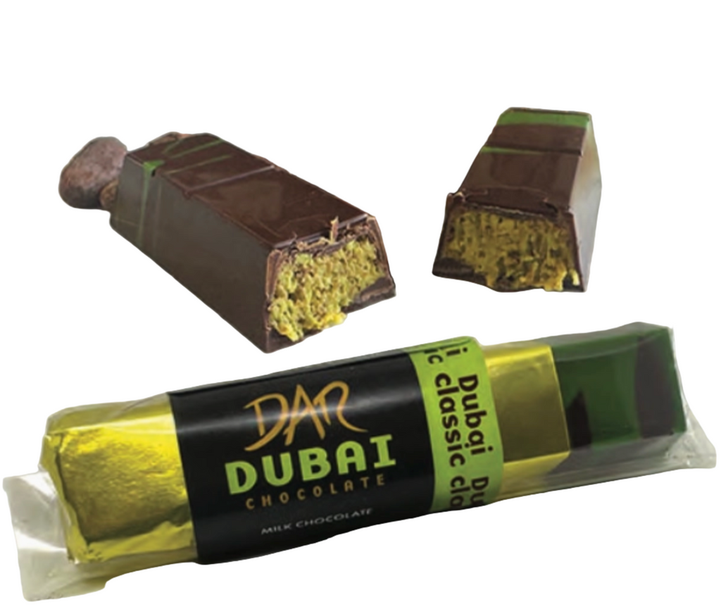 Dar milk chocolate Dubai bar unwrapped and in packaging against a white background