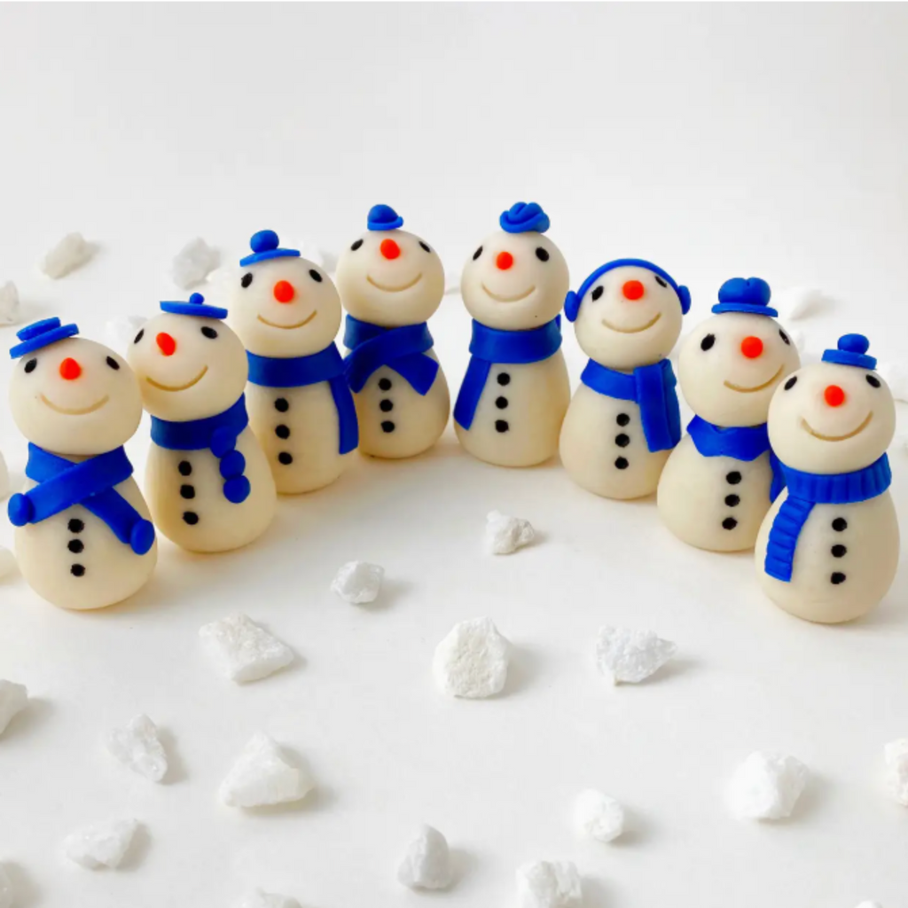 Hanukkah Candy Snowmen on a white background with white rocks