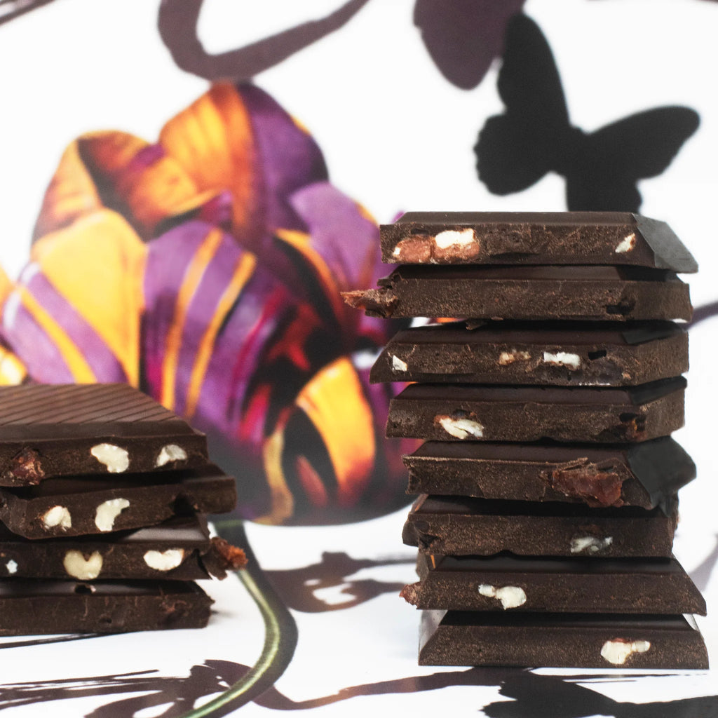 Unwrapped, stacked Rainier Cherry Truffle Bars on a table with a floral design