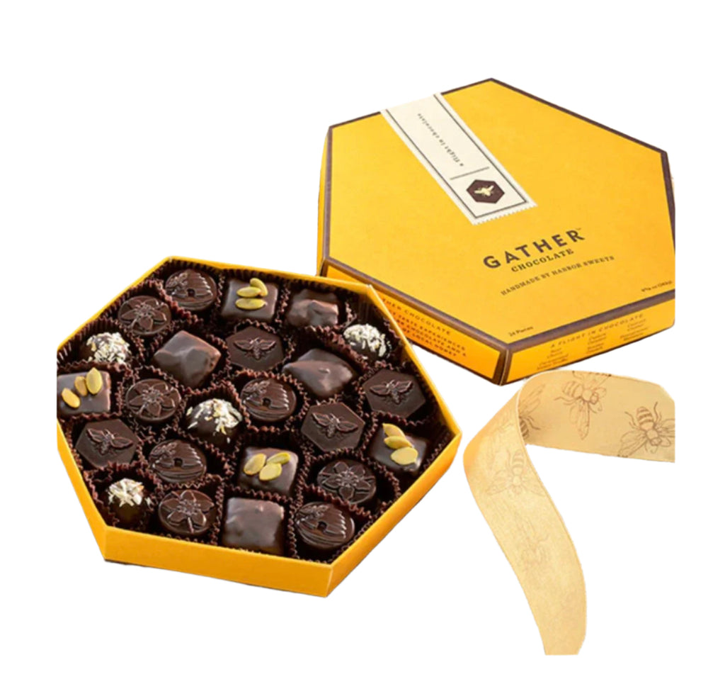 Hexagonal Gather Chocolate Gift Assortment, Honey Based Truffles chocolate box net to a loose ribbon on a wood background