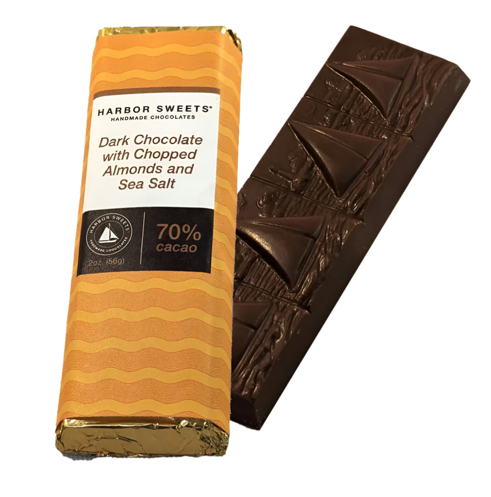 An unwrapped and an wrapped  Harbor Sweets dark chocolate bar with chopped almonds and sea salt on a white background