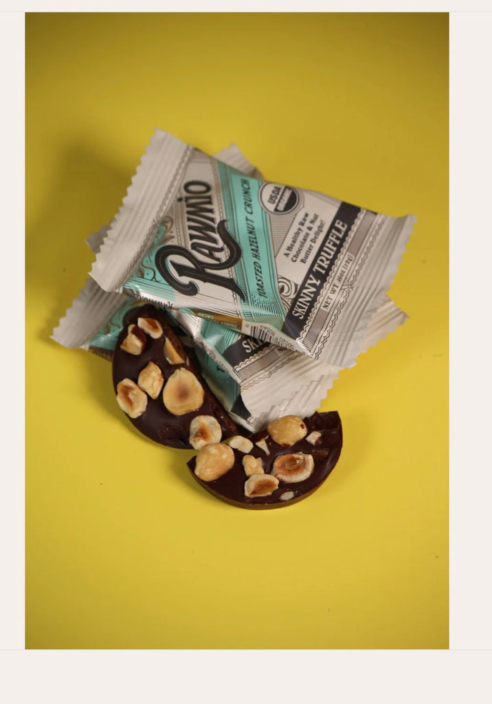 A picture of Rawmio's unwrapped Skinny Truffle - Toasted Hazelnut Crunch against a yellow background