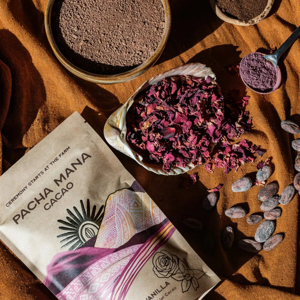 Pacha Mana Cacao packaging with cacao powder, dried flowers, and beans on a rustic background