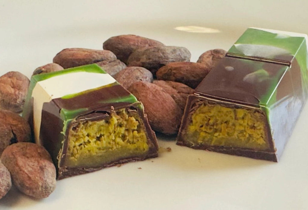 DAR Chocolate Dubai bar and  cacao beans against a light background