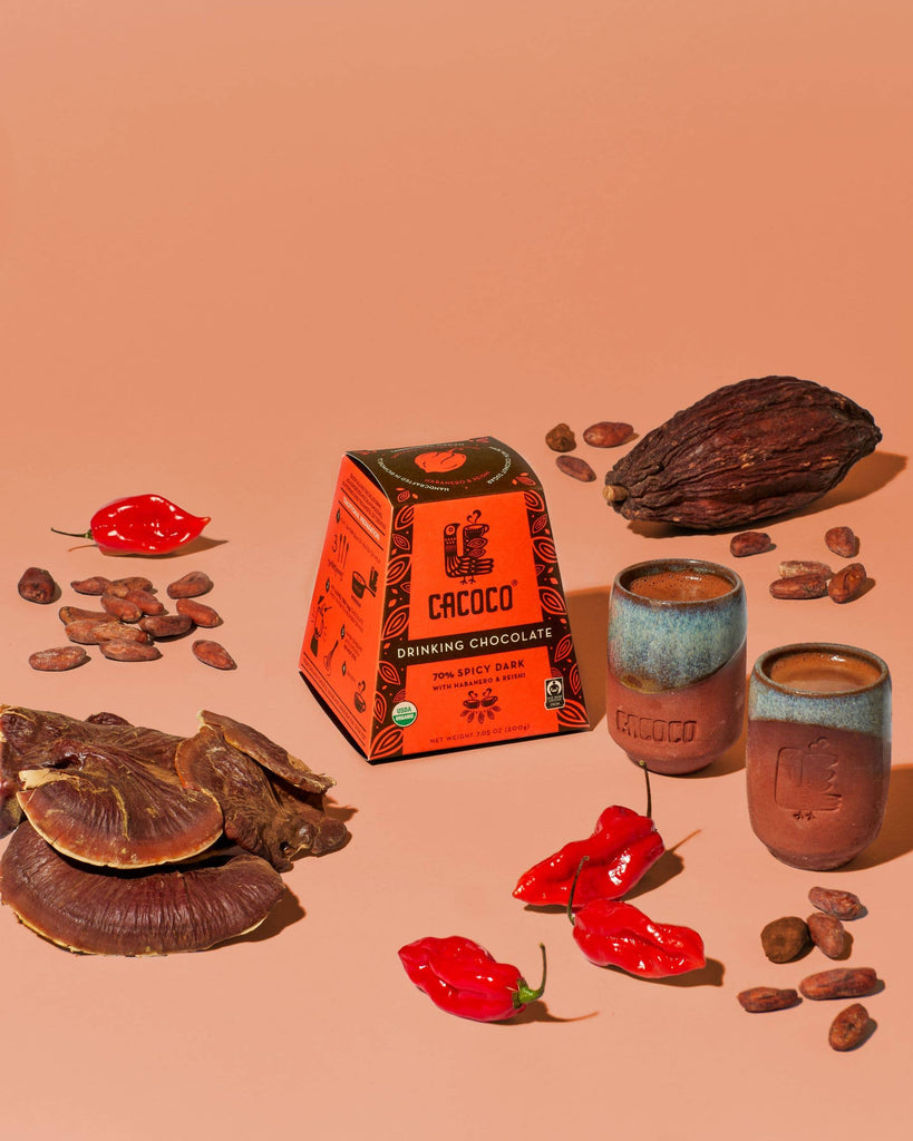 70% Spicy Dark Drinking Chocolate with varying ingredients on an orange table