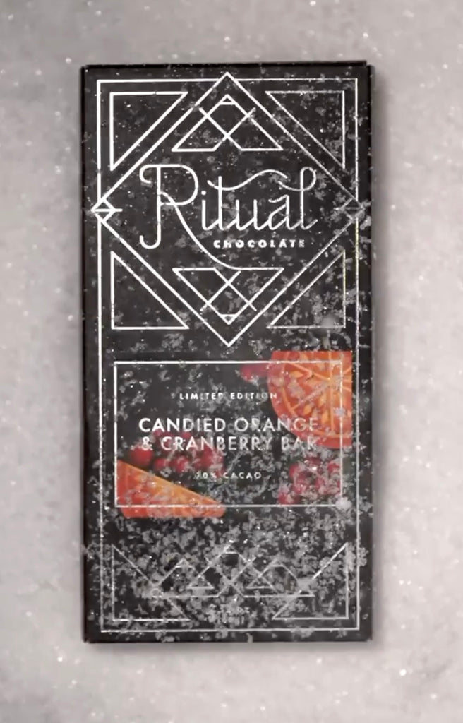 Ritual Orange Cranberry Bar packaging with decorative design on a white snowy background