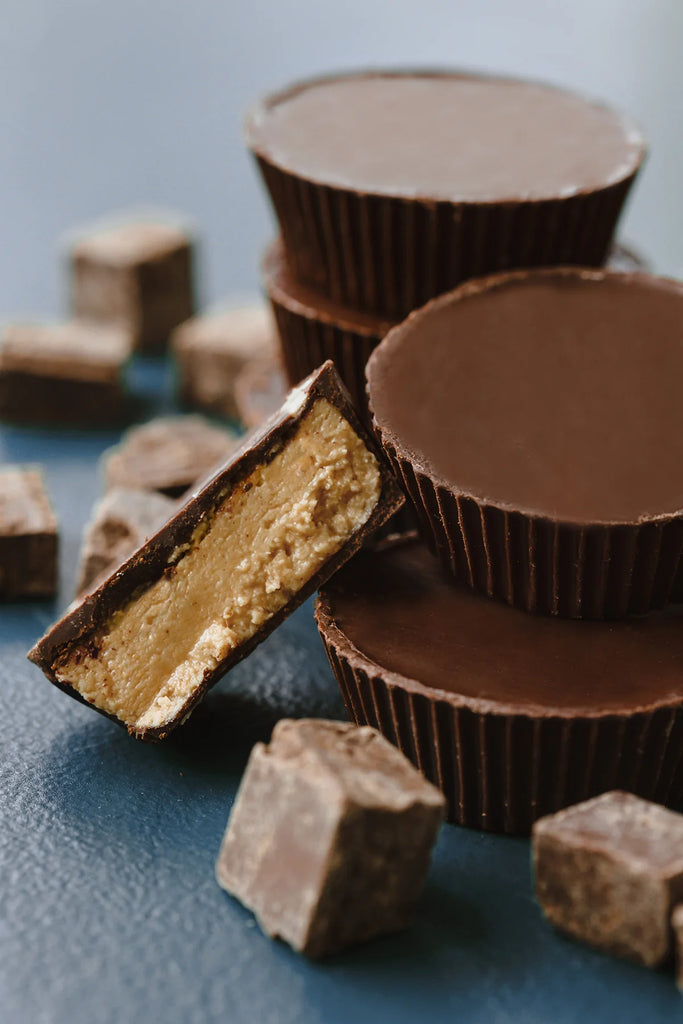 Unwrapped Nuttin’ But Crunch cups on a blue table