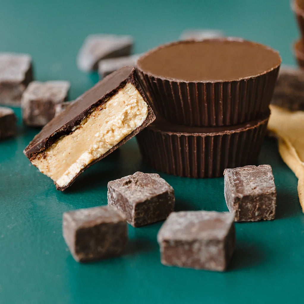 Unwrapped Butter Believe It cups on a green table