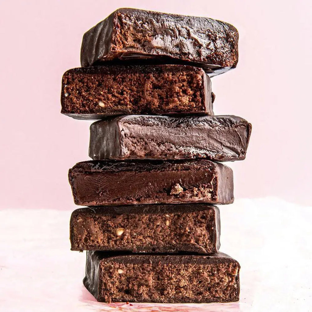 Stack of chocolate bars on a light pink background