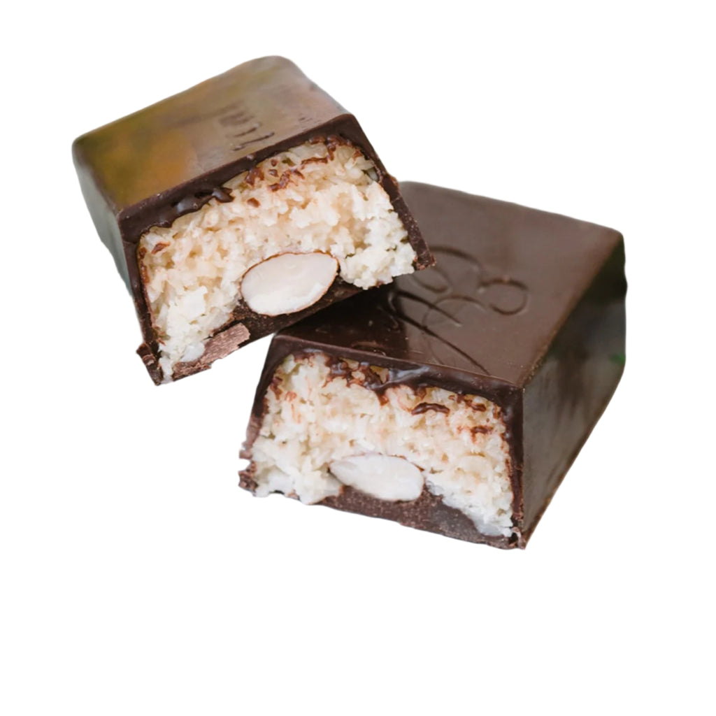 Ethereal day dream candy bar unwrapped and almonds against a white background