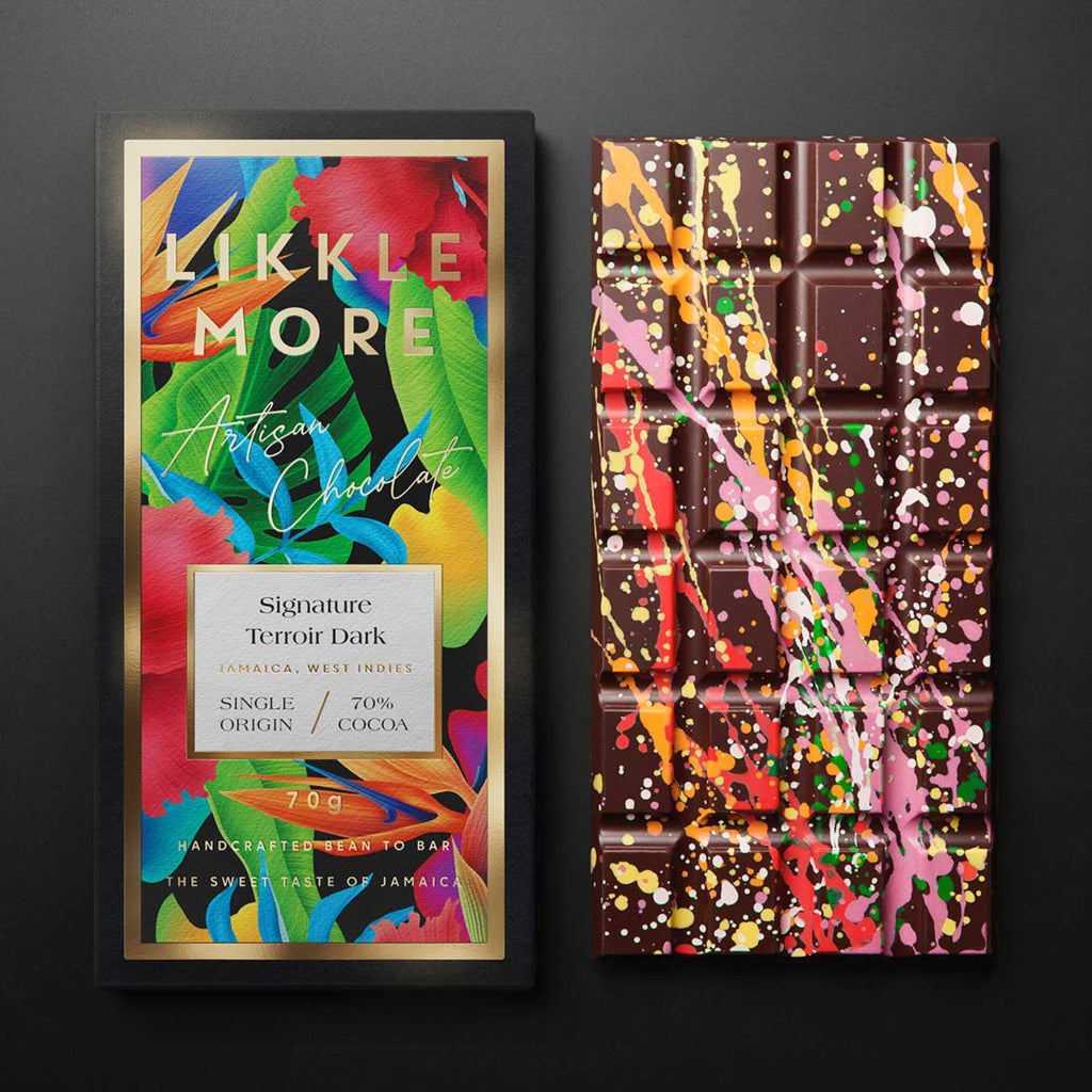 Likkle More Signature Terroir Dark bar with colorful packaging on a black background