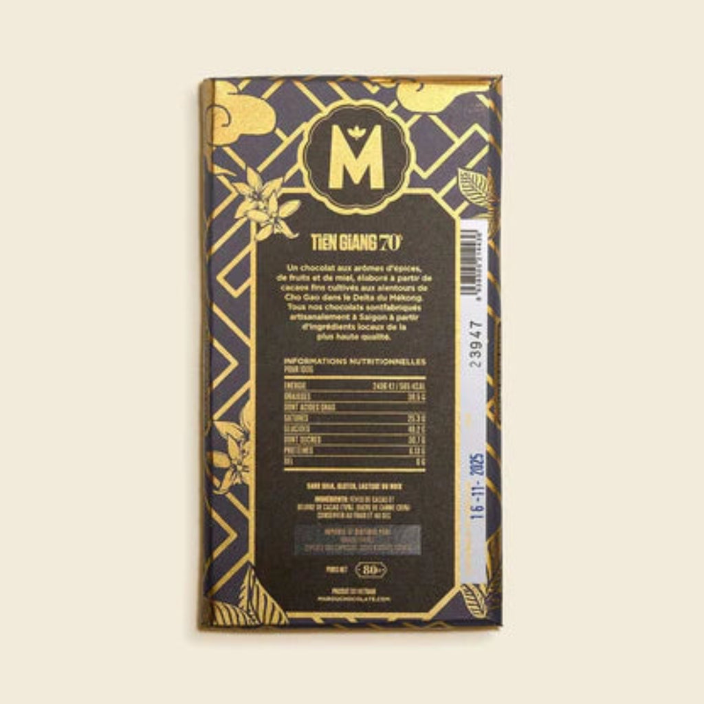 Back view of a Marou Tien Giang 70%, chocolate bar packaging with gold text and design on a light background