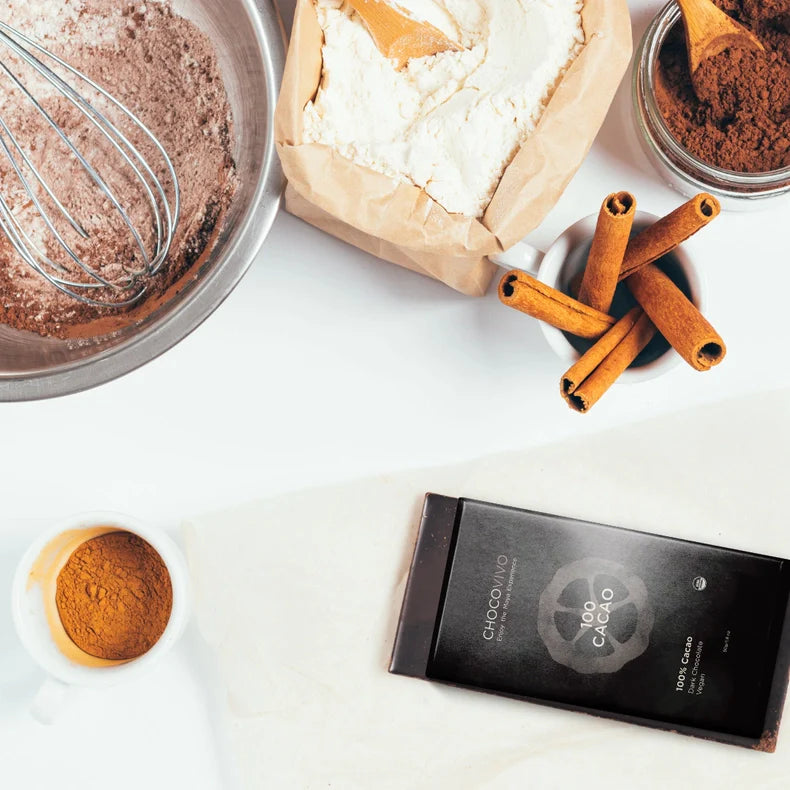 ChocoVivo 100% Cacao Dark Bar, with its ingredients on a white table. 