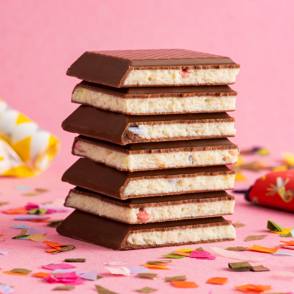 Unwrapped, stacked Seattle Chocolate Happy Birthday Truffle Bars at The Chocolate Dispensary